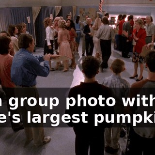 for a group photo with the state's largest pumpkin.