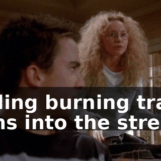 rolling burning trash cans into the street.