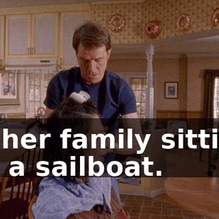 of her family sitting on a sailboat.