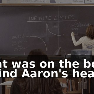 What was on the board behind Aaron's head?