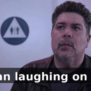 [man laughing on TV]