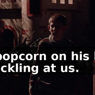 of popcorn on his lap, chuckling at us.