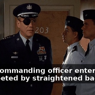 The commanding officer enters and is greeted by straightened backs