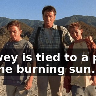 Dewey is tied to a post in the burning sun.