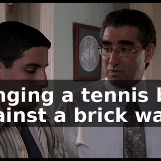 banging a tennis ball against a brick wall.