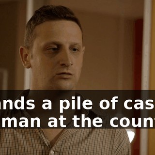 - Hands a pile of cash to the man at the counter.