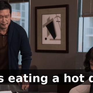 He's eating a hot dog.