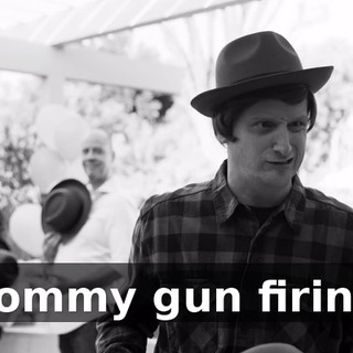 [Tommy gun firing]