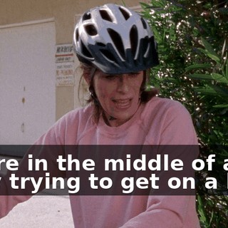 You're in the middle of an alley trying to get on a bike.