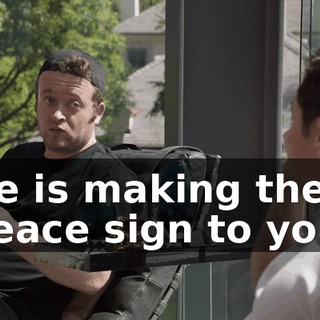 He is making the peace sign to you.